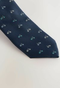 Marineblauer Seidenkrawatte mit einem strukturierten, gerippten Design, das kleine, gestickte Fahrradmuster in Weiß, Silber und Türkis aufweist.