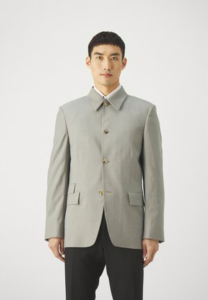 Light gray tailored jacket with a high collar, button front, and two front pockets. Features a smooth texture and clean lines.