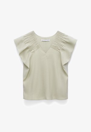 Light beige short-sleeve blouse with V-neck and pleated fabric detailing on shoulders, loose fit, made of textured material.