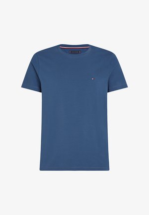 Blue cotton t-shirt with a crew neck and short sleeves. Features a small logo in red, white, and blue on the left chest. Smooth texture.