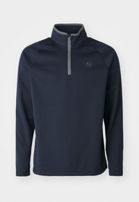 Pullover in pile colore navy con colletto a metà zip, bordatura grigia e trama a coste. Presenta un logo discreto sul lato sinistro del petto. Maniche lunghe.