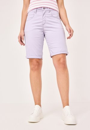 Lilac denim shorts with rolled cuffs, five-pocket design, and a classic waistband. Paired with white platform sneakers.