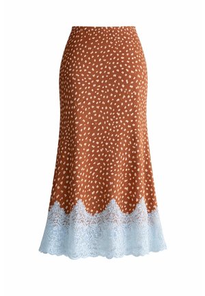 Jupe mi-longue marron à petits pois blancs avec bordure en dentelle blanche à l'ourlet, silhouette évasée, sans fermetures visibles.