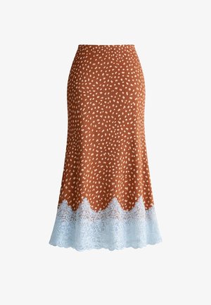 Brązowa spódnica midi w małe białe kropki z białą koronkową lamówką na dole, rozkloszowany fason, bez widocznych zapięć.