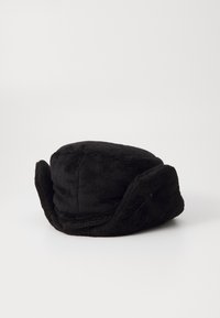 Sort faux fur hat med ørerne flap, rund krone og blød texture. Flapperne kan bæres ned eller gemmes op for stilvariationer.
