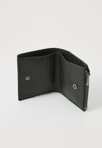 Black leather wallet features multiple card slots, a zippered compartment, and textured interior. Detailed with a metal snap button.
