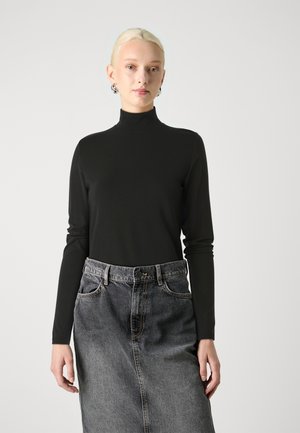 Black long-sleeve turtleneck top paired with a gray denim skirt. The top has a smooth texture; the skirt features a button and pockets.