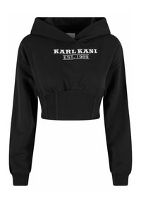 Must värviline lühike kapuutsiga see, mis on valmistatud pehmest kangast, millel on reguleeritav kapuuts, soonikuga äär ja valge tikandiga logo "KARL KANI EST. 1989."