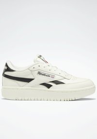 White leather sneaker with black accents, padded collar, Reebok logo on side and tongue, textured rubber sole, and perforated detail on toe.