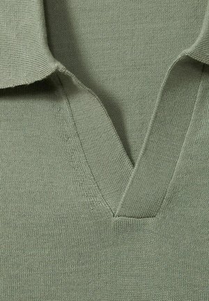 Cotton polo shirt in muted green, featuring a v-neck design, short collar, and textured knit fabric with subtle vertical lines.