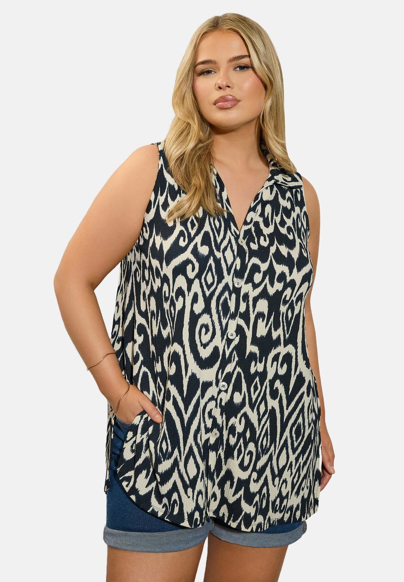 Ärmelloses Hemd in Marineblau und Creme mit einem abstrakten Muster, ausgestattet mit einer Knopfleiste vorne und Seitentaschen, hergestellt aus leichtem Stoff.