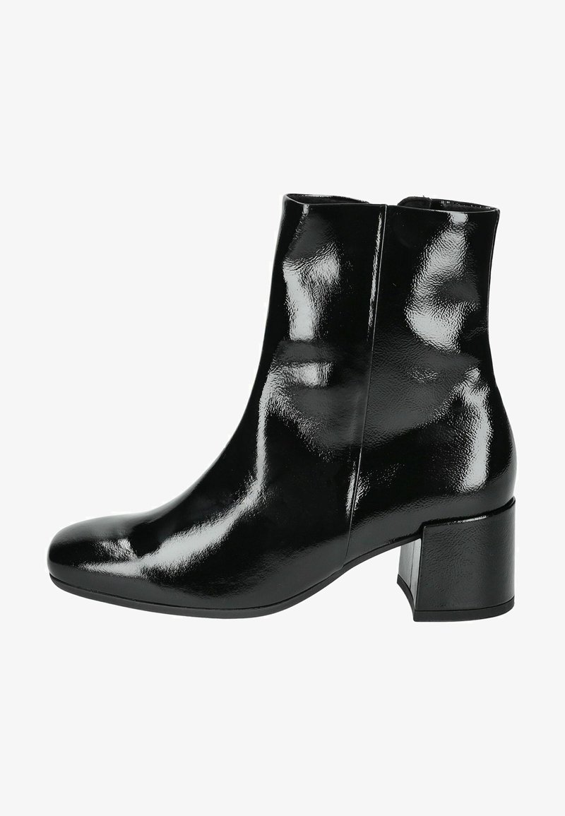 Bottines vernis noires à bout arrondi, avec un léger talon et une texture lisse. Présente un design épuré et une surface brillante.