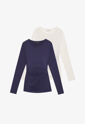Long-sleeve top set in navy and white. Ribbed texture, round neckline, fitted design. The navy top features a waist accent detail.