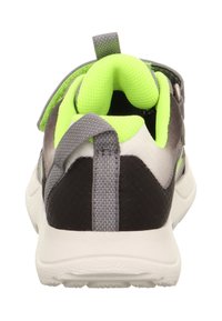 Sneaker sportivo in grigio, nero e bianco, con un collare e una linguetta imbottiti di un vivace verde, dotato di un pratico tirante posteriore texturizzato e di una fascia regolabile.