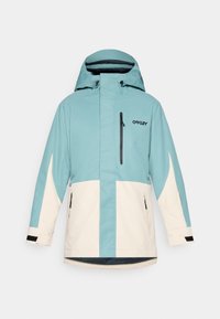 Teal and cream waterproof jacket with a hood, featuring a front zip, black accents, and two side pockets. Logo displayed on chest.