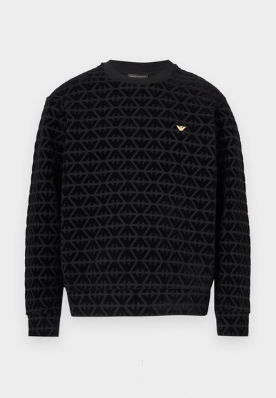 Čierna mikina s okrúhlym výstrihom a textúrovaným geometrickým vzorom, s detailom zlatého loga na hrudi a rebrovanými manžetami a lemom.