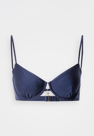 Tumesinist värvi rinnahoidja, millel on sile viimistlus, tugijalad, reguleeritavad rihmad ja kuldne tähetis keskosas. Omab konksuga sulgemist.