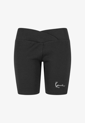 Crne rebraste biciklističke kratke hlače sa širokim pojasom i bijelim logom. Dizajn se odlikuje uskim krojem i do koljena dugim rubom.
