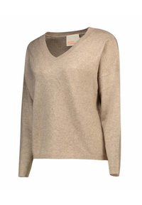 Pull en V beige à manches longues, fabriqué dans un matériau doux. Présente un ourlet côtelé et une étiquette indiquant "cachemire absolu."