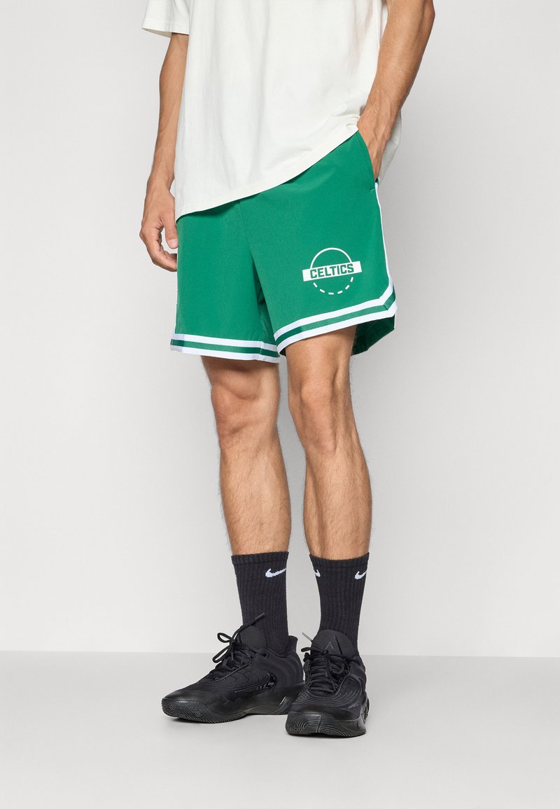 Grønne basketballshorts med et hvidt "CELTICS" logo, kontrasterende hvide side-striber og en elastisk talje.
