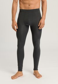 Leggings gris foncé en matériau lisse et extensible. Ils présentent un design ajusté avec une couture frontale et une taille élastique.
