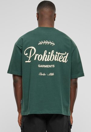 Green short-sleeve t-shirt made of cotton, featuring large cream text on the back, with a decorative leaf above "Prohibited Garments."