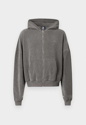 Hallidega hall zip-up kapuutsiga, ribakujulise tekstuuriga, küljetaskutega ja laia lõikega. Omab hõbedast metallist detaile ja elastseid mansette.