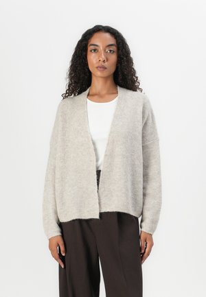 Light beige knitted cardigan with a relaxed fit, open front, and long sleeves. Soft texture, ribbed edges, and a slightly cropped length.