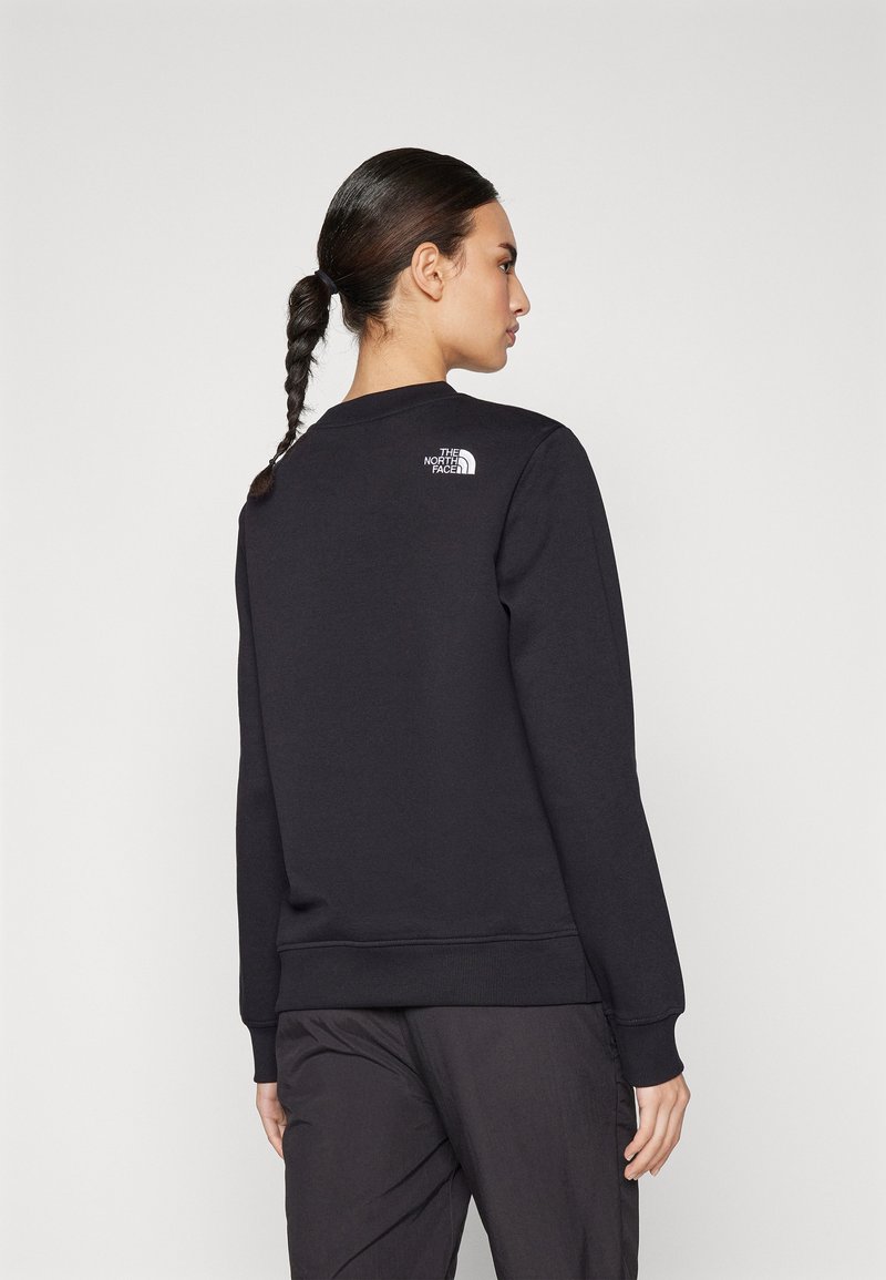 Zwarte sweatshirt van zacht materiaal, met een ronde halslijn, geribbelde manchetten en zoom, voorzien van een klein wit logo op de achterkant.