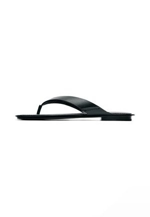 Black flat flip-flop sandal with a single wide strap and toe post on a white background.