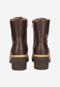 Bottes courtes en cuir marron avec doublure en fausse fourrure, fermetures éclair latérales, semelle en caoutchouc marron robuste et petit talon en bois.
