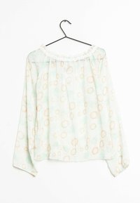 Lightweight, sheer blouse in mint green with a floral pattern featuring golden sun-like designs. Elasticized neckline and long sleeves.