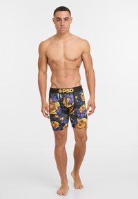 Boxer da uomo neri con un vivace design floreale che presenta rose gialle e farfalle viola. Realizzati in un tessuto liscio e elasticizzato.