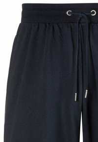 Navy blue sweatpants with an elastic waistband, adjustable drawstring, and silver accent hardware. Soft fabric with a relaxed fit.