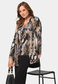 Multikleurige blouse met een bloemenpatroon in zwart, beige en grijs, met lange mouwen en een losse pasvorm. Katoenmix stof.