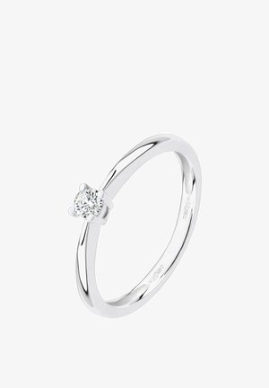 Strieborný solitaire prsteň s jediným okrúhlym briliantovým diamantom zasadeným na lesklom, hladkom ráme.