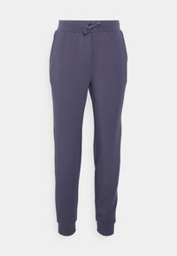 Pantalon de jogging bleu foncé avec taille élastique, cordon de serrage et bas resserrés sur un fond blanc.