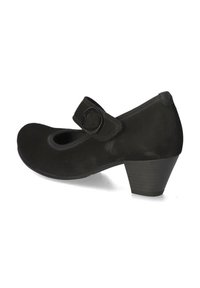 Black suede Mary Jane shoe with a rounded toe, strap featuring a circular buckle, and a low, angled heel. Smooth texture throughout.