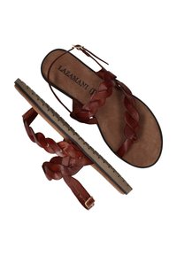 Bruine leren sandalen hebben gevlochten banden, een platte zool en een gespsluiting voor aanpassing. Het interieur is zacht, met een geperst merklogo.