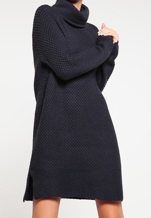 Vestito a maglia blu navy con un motivo testurizzato, collo alto, maniche lunghe e spacchi laterali; realizzato in un materiale spesso e accogliente.