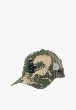Camouflage-patterned cap with a green and beige color scheme, mesh back, and a black embroidered "LA" logo on the front.
