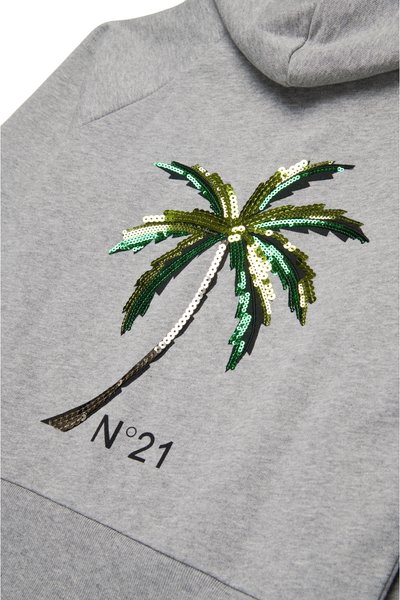 Grå hettegenser med en palme-design i grønt og gull med paljetter, med teksten "N°21" under i svart. Glatt stofftekstur.