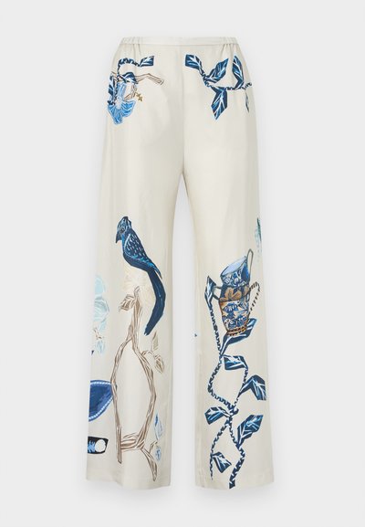 Pantalon crème à jambes larges avec imprimés botaniques et oiseaux bleus, comprenant des branches, des fleurs et un oiseau détaillé perché sur une branche.