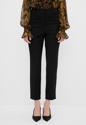 Black tailored trousers with a straight leg, smooth fabric, mid-rise waistband, and minimalistic design. Features no visible hardware or patterns.