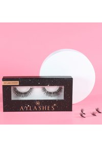 DIY Lash System package featuring two black false eyelashes in a clear window. Includes three additional individual lashes on a pink background.