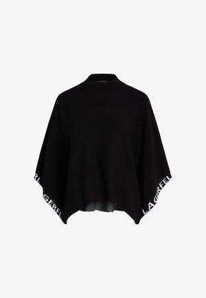 Sort strikket poncho med høj hals og løs pasform, der har kontrastfyldt hvid tekst på kanten. Blød tekstur, minimalistisk design.