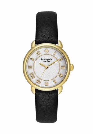 Rund gylden ur med sort læderrem, hvid urskive med romertal i guld og Kate Spade New York-logo.