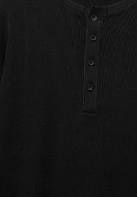 Chemise noire en maille côtelée avec un col Henley doté de quatre boutons noirs sur le devant.
