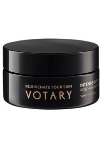 Pot noir rond avec une finition mate lisse et un couvercle élégant. Le texte doré affiche le nom du produit et les détails. Capacité : 50 ml.