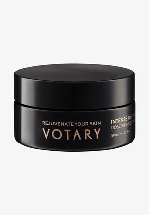 Sort rund krukke med en glat mat finish og et slankt låg. Guldtekst viser produktnavn og detaljer. Kapacitet: 50 ml.